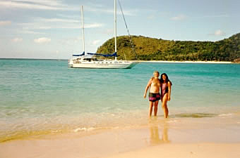 Art and Anne in the surf with the Grand Oais in the background