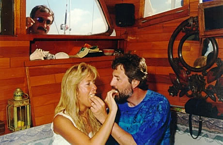 The couple feed each other wedding cake, nicely