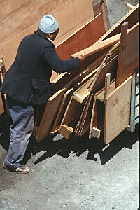 A dock worker with lumber