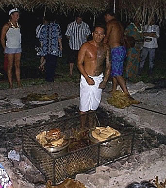 Removing the cooked foods from the pit
