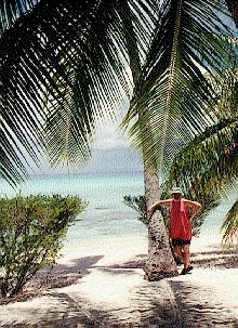 Art standing in front of a palm tree