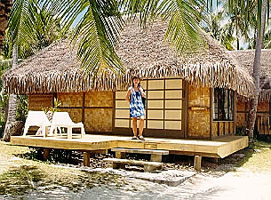 Anne standing in front of our beachfront hut